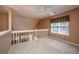 Second floor loft area with neutral carpet, window and ceiling fan overlooking the stairs at 149 Darcy Ave, Goose Creek, SC 29445