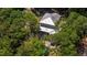 Aerial view of a home surrounded by lush trees, a private pool, and a screened-in porch at 1510 Old Rosebud Trl, Awendaw, SC 29429