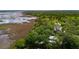 Aerial shot showcasing the beautiful home, marsh, and water views at 1510 Old Rosebud Trl, Awendaw, SC 29429