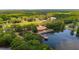 Gorgeous aerial view of a sprawling estate with a pond, lake access, a red roofed venue and lush surroundings at 1510 Old Rosebud Trl, Awendaw, SC 29429