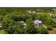 Aerial view of a few houses nestled in the woods featuring lush greenery and a river in the background at 1510 Old Rosebud Trl, Awendaw, SC 29429