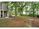 Backyard featuring manicured lawn, mature trees, patio and swimming pool surrounded by foliage at 1510 Old Rosebud Trl, Awendaw, SC 29429