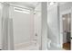 Bright bathroom featuring a subway tiled shower and tub, with a window for natural light and ventilation at 1510 Old Rosebud Trl, Awendaw, SC 29429
