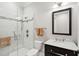 Bathroom featuring shower with glass door, with dark vanity, square mirror, and light fixture at 1510 Old Rosebud Trl, Awendaw, SC 29429