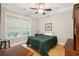 Cozy bedroom featuring a ceiling fan, natural light, and warm wooden flooring at 1510 Old Rosebud Trl, Awendaw, SC 29429