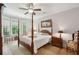 Primary bedroom features a four post bed and light-filled windows at 1510 Old Rosebud Trl, Awendaw, SC 29429