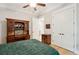 Bedroom features a ceiling fan, wooden floors, and a large antique desk at 1510 Old Rosebud Trl, Awendaw, SC 29429