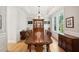 Spacious dining room with a long wooden table, chairs, and natural light at 1510 Old Rosebud Trl, Awendaw, SC 29429