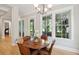 Charming dining area with a wooden table, leather chairs, and views of outdoor scenery through large windows at 1510 Old Rosebud Trl, Awendaw, SC 29429