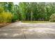 Long concrete driveway leading to a beautifully landscaped property with mature trees at 1510 Old Rosebud Trl, Awendaw, SC 29429