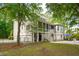 Charming two-story home features a screened porch, garage, and beautifully landscaped yard at 1510 Old Rosebud Trl, Awendaw, SC 29429