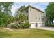 Rear exterior of the house featuring a garage, stairs, and green lawn at 1510 Old Rosebud Trl, Awendaw, SC 29429