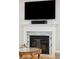 Close-up of a stunning fireplace with a marble hearth, modern mantle, and wall mounted TV above it at 1510 Old Rosebud Trl, Awendaw, SC 29429
