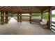 Inviting gazebo interior with wooden beams, built-in benches, and tranquil lake views, creating a perfect spot for relaxation at 1510 Old Rosebud Trl, Awendaw, SC 29429