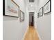 Well-lit hallway adorned with decorative artwork, leading to various rooms in the home at 1510 Old Rosebud Trl, Awendaw, SC 29429