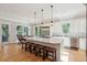 Gourmet kitchen with stainless appliances, center island with seating, and adjacent breakfast nook with views at 1510 Old Rosebud Trl, Awendaw, SC 29429