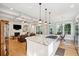 Open kitchen view with center island, stainless steel appliances, and seamless flow into the living spaces at 1510 Old Rosebud Trl, Awendaw, SC 29429