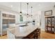 A gourmet kitchen featuring a large center island, stainless appliances, and custom cabinetry at 1510 Old Rosebud Trl, Awendaw, SC 29429