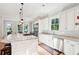 Bright kitchen with a large center island featuring a stovetop and barstool seating at 1510 Old Rosebud Trl, Awendaw, SC 29429