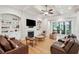 Bright living room with coffered ceiling, fireplace, built-in bookshelves and wet bar area for entertaining Gathering and friends at 1510 Old Rosebud Trl, Awendaw, SC 29429
