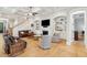 Bright and open living room featuring hardwood floors, coffered ceilings, built-in bookshelves and a cozy fireplace at 1510 Old Rosebud Trl, Awendaw, SC 29429