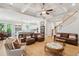 Open-concept living area connects to the kitchen, featuring wood floors, a coffered ceiling and a cozy seating arrangement at 1510 Old Rosebud Trl, Awendaw, SC 29429