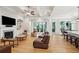 Bright living area with fireplace, built-ins, and sliding glass doors to outdoor view at 1510 Old Rosebud Trl, Awendaw, SC 29429