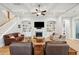 Open-concept living room featuring a fireplace, built-ins, hardwood floors, coffered ceilings, and plenty of seating at 1510 Old Rosebud Trl, Awendaw, SC 29429