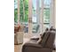 View from living room showing glass doors leading to a deck with scenic lake views at 1510 Old Rosebud Trl, Awendaw, SC 29429