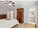 Spacious bedroom with light hardwood floors, ceiling fan, and an ensuite bathroom for added convenience at 1510 Old Rosebud Trl, Awendaw, SC 29429