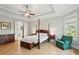 A spacious main bedroom with hardwood floors, lots of natural light, tray ceilings, and ensuite access at 1510 Old Rosebud Trl, Awendaw, SC 29429