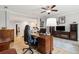 Open concept office space with dark wood desk and comfortable arm chairs at 1510 Old Rosebud Trl, Awendaw, SC 29429