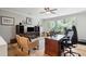 Home office with a dark wood desk, cabinets, and a comfortable seating area at 1510 Old Rosebud Trl, Awendaw, SC 29429
