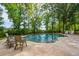 Beautiful backyard pool surrounded by trees and patio space, creating a private retreat at 1510 Old Rosebud Trl, Awendaw, SC 29429