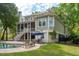 Backyard features a pool, patio, and a spacious grassy area, great for outdoor fun at 1510 Old Rosebud Trl, Awendaw, SC 29429