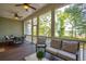 Enjoy the comfort of this screened porch featuring ceiling fans, comfortable seating and views of the marsh and woods beyond at 1510 Old Rosebud Trl, Awendaw, SC 29429