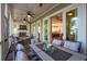 The cozy outdoor porch features a fireplace, ceiling fans and access to a kitchen view for easy indoor-outdoor living at 1510 Old Rosebud Trl, Awendaw, SC 29429