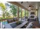 Inviting screened porch with a fireplace, ceiling fans and plenty of room for seating and dining overlooking the pool at 1510 Old Rosebud Trl, Awendaw, SC 29429