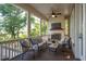 Relaxing screened-in porch with comfortable seating, a fireplace, a mounted TV, and tranquil views of the surrounding landscape at 1510 Old Rosebud Trl, Awendaw, SC 29429