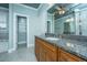 Bathroom with granite counters, wood cabinets, a soaking tub, and a glass shower with neutral stone tile at 1512 Eagle Landing Blvd, Hanahan, SC 29410