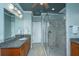 Bathroom featuring granite countertops, wood cabinets, a glass shower, and a large mirror at 1512 Eagle Landing Blvd, Hanahan, SC 29410