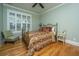 Bedroom featuring a bronze bed frame, hardwood floors, and natural light from the window at 1512 Eagle Landing Blvd, Hanahan, SC 29410