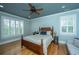 Comfortable bedroom featuring a wood-frame bed, hardwood floors, and natural light from the shuttered windows at 1512 Eagle Landing Blvd, Hanahan, SC 29410