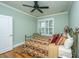 Cozy bedroom featuring a bronze bed frame, natural light, and a ceiling fan for added comfort at 1512 Eagle Landing Blvd, Hanahan, SC 29410