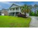 Inviting coastal home featuring a two-story design, lush lawn, and a convenient driveway at 1512 Eagle Landing Blvd, Hanahan, SC 29410
