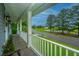 Relaxing porch view overlooking a peaceful street with mature trees and a serene lake at 1512 Eagle Landing Blvd, Hanahan, SC 29410