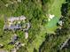 A lush, aerial view of villas nestled among trees, adjacent to a pristine golf course with sand traps at 153 High Hammock Villas, Seabrook Island, SC 29455