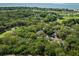 Overhead shot of property surrounded by trees, golf course and lagoons with ocean views in the distance at 153 High Hammock Villas, Seabrook Island, SC 29455
