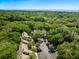 Aerial shot features a community surrounded by lush trees, golf course and the ocean in the background at 153 High Hammock Villas, Seabrook Island, SC 29455