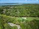 An aerial shot highlights homes by golf course, set in mature trees, with green and sand traps visible at 153 High Hammock Villas, Seabrook Island, SC 29455